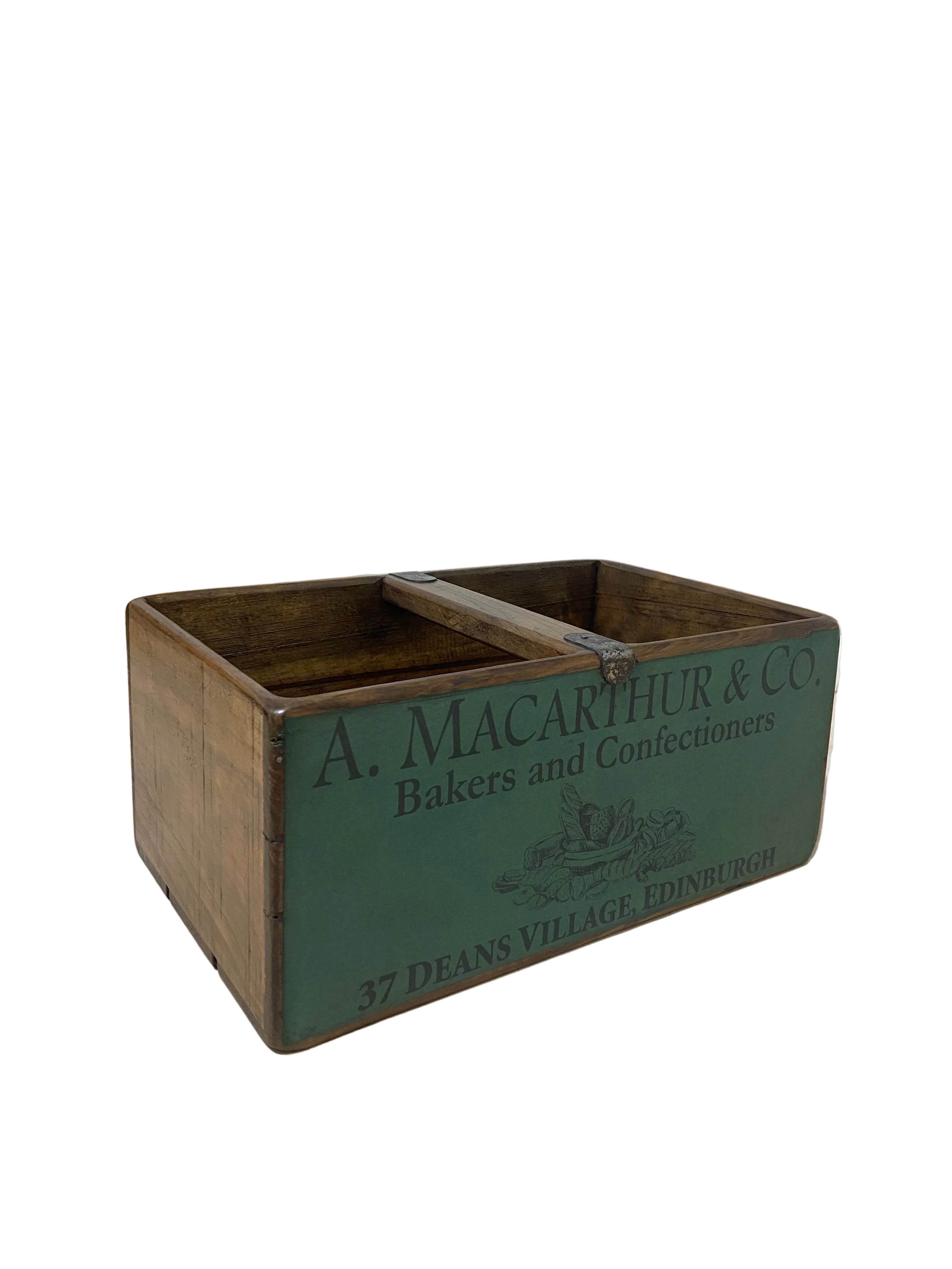 Vintage wooden crate with 'A. Macarthur & Co' branding on a light-colored floor.