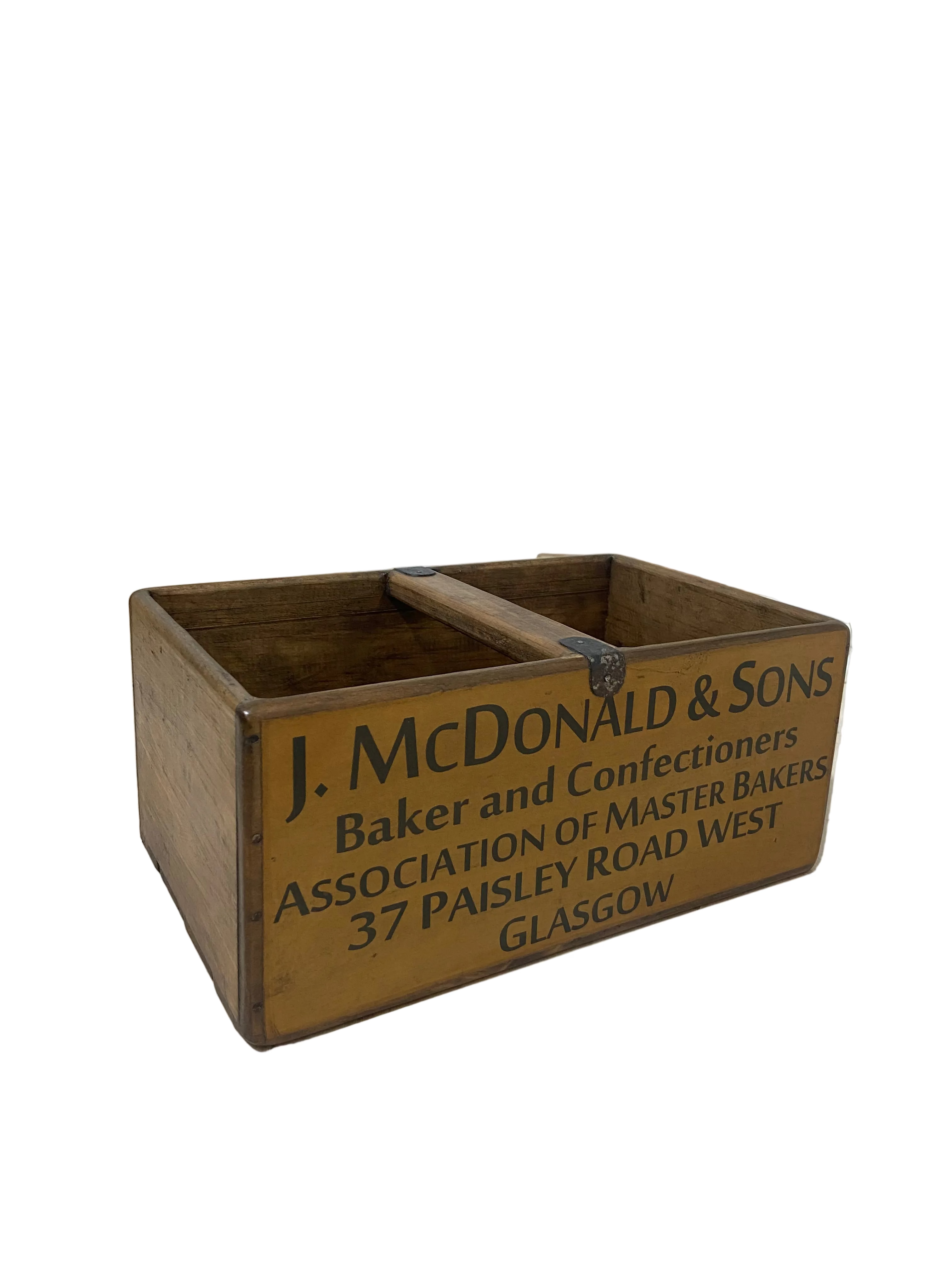 Wooden box with engraved text on a light wooden floor.