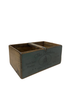 Vintage wooden crate with 'The Beehive' branding on a concrete floor.