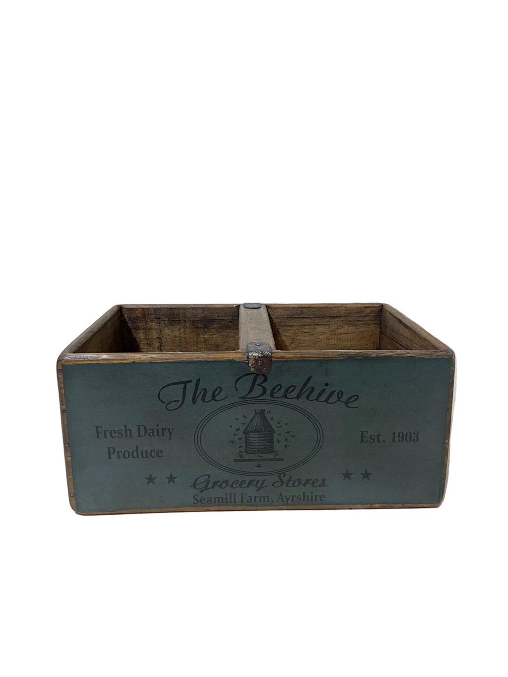 Wooden crate with 'The Beehive' branding on a light wooden floor.