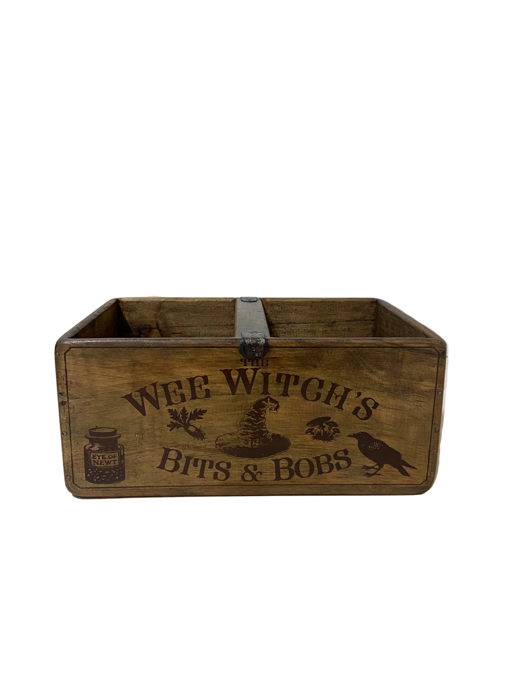 Wooden box with 'The Wee Witch's Bits & Bobs' text on a light wooden floor.