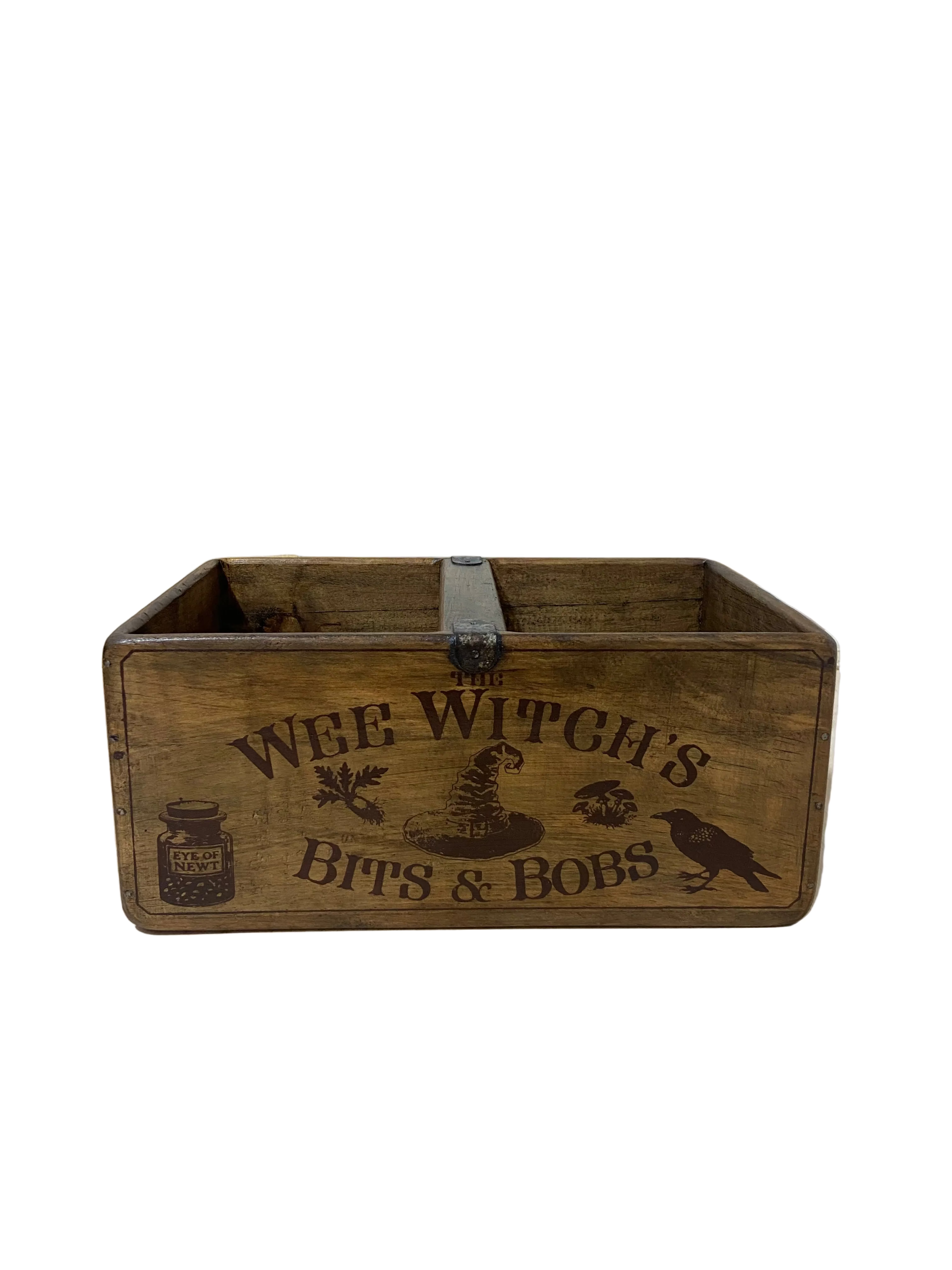 Wooden box with 'The Wee Witch's Bits & Bobs' text on a light wooden floor.