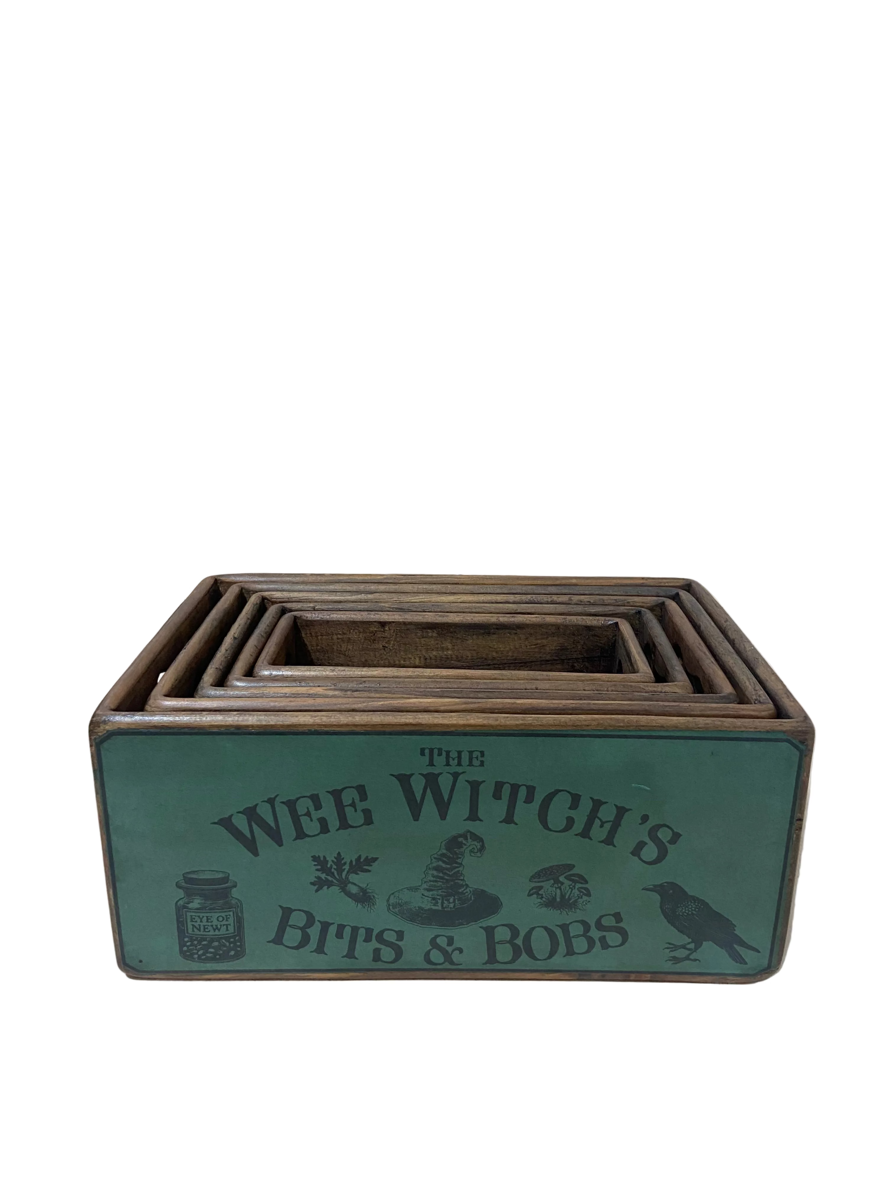 Wooden box with 'The Wee Witch's Bits & Bobs' text on a tiled floor background