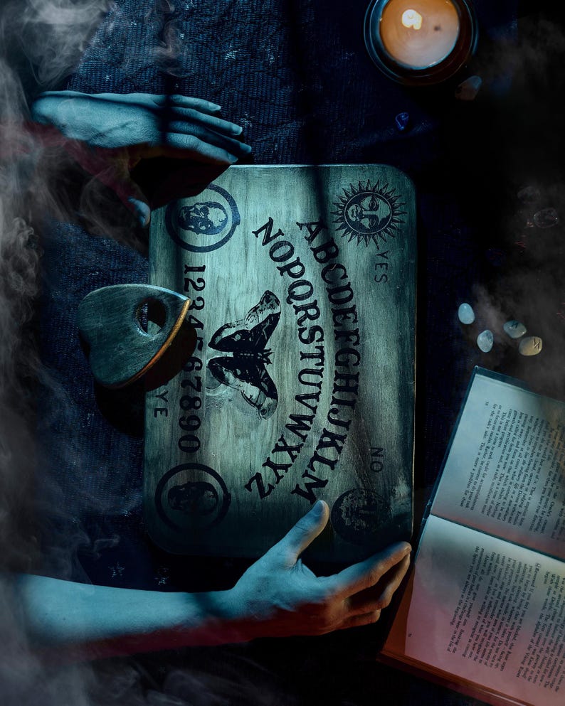 Atlas Moth spirit board with candle and book